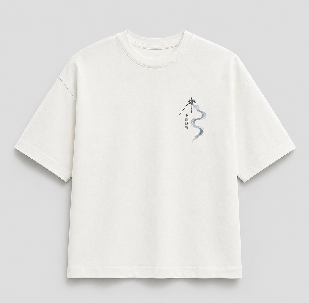 An off-white short-sleeve t-shirt with a small graphic print on the left chest featuring a black silhouette of a person holding a sword and a blue-gray wavy line with vertical Chinese characters, displayed on a neutral gray background.