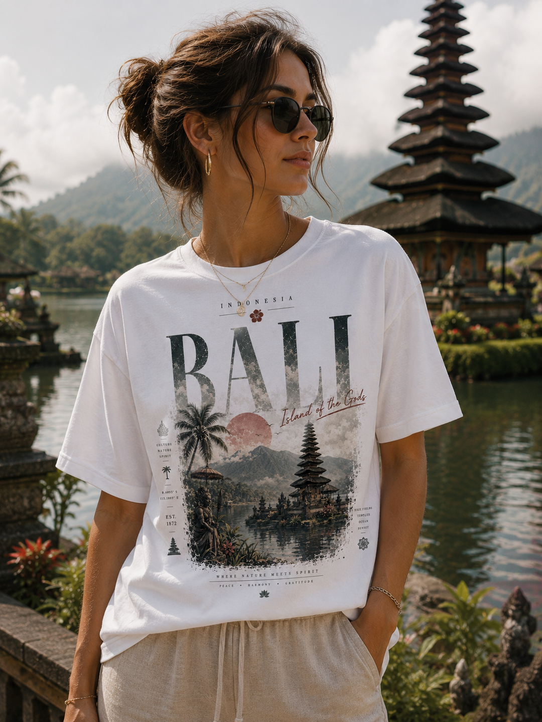 A woman wearing a white graphic t-shirt with a &