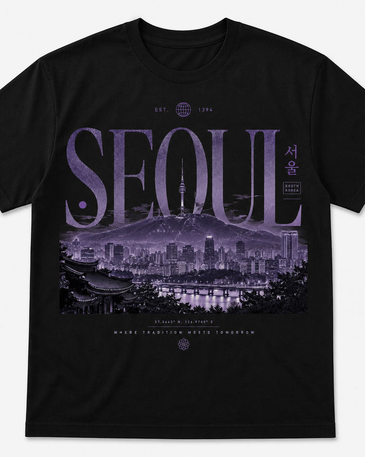 A black short-sleeve crewneck t-shirt featuring a large graphic print of the Seoul skyline in purple tones, with the word 'SEOUL' in stylized letters and Korean characters on the front, shown against a light gray background.